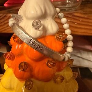 Silver 'Hope' on the front hope over fear on the back white buffalo beads